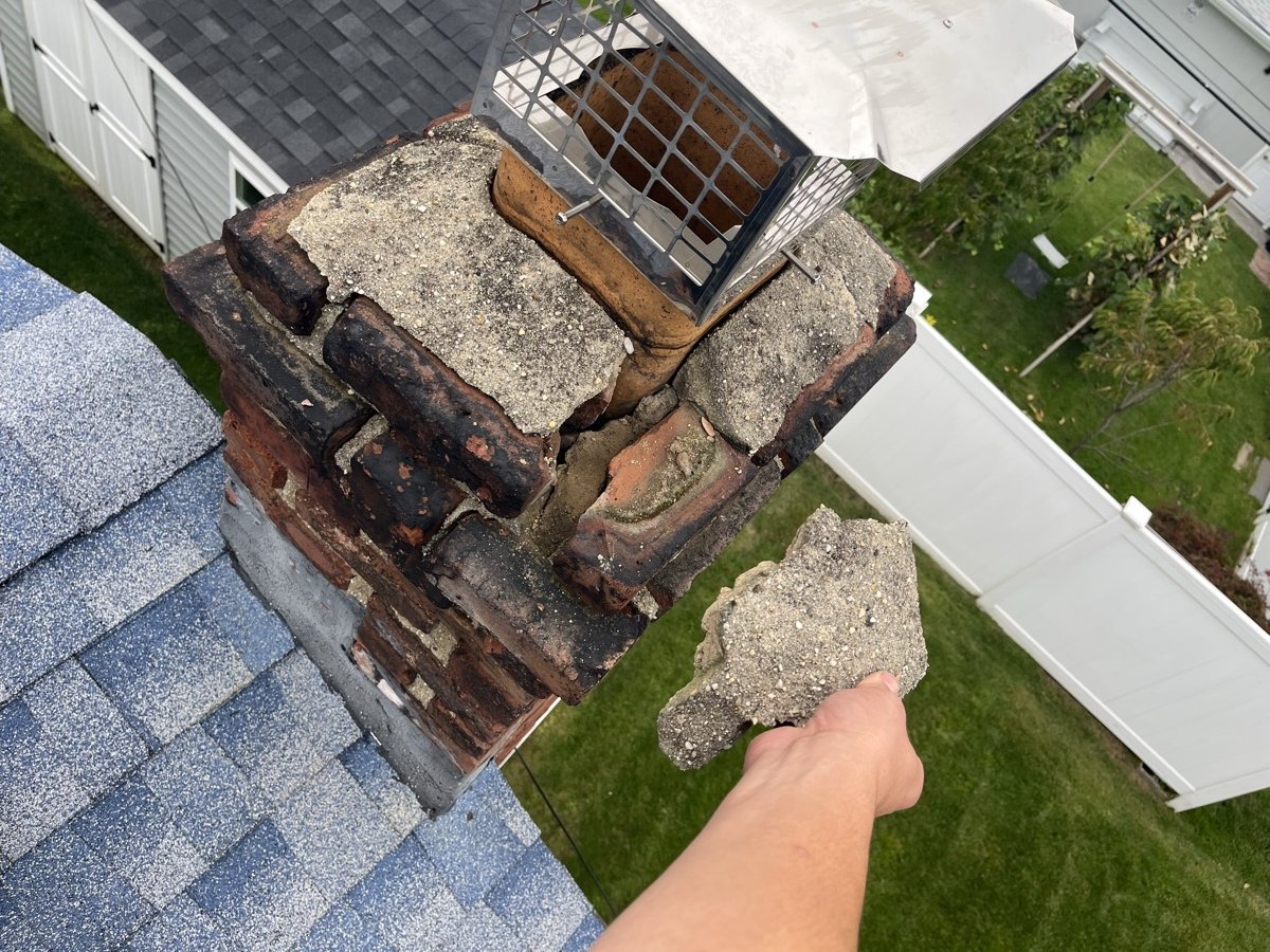 Severely damaged chimney crown before repair
