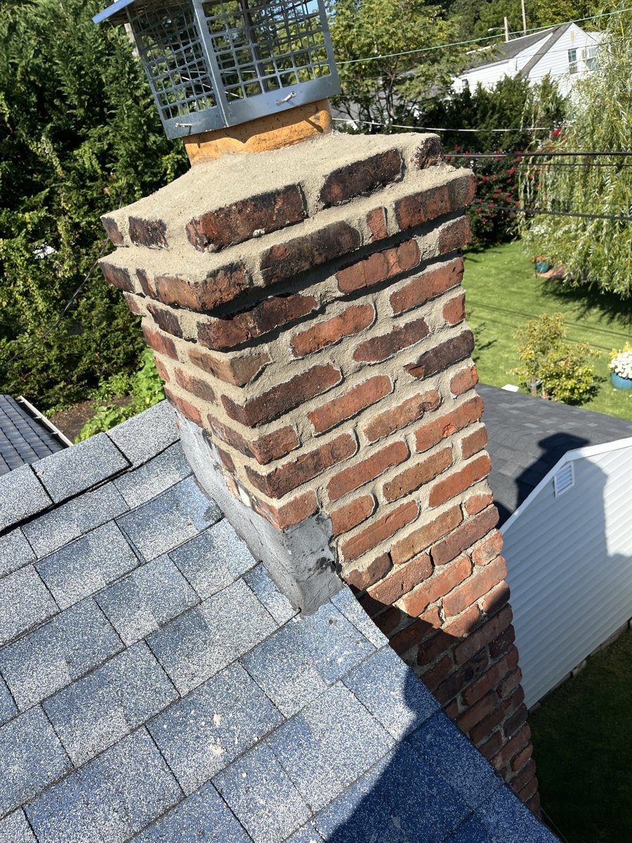 Completed chimney repair with new crown and cap from alternate angle