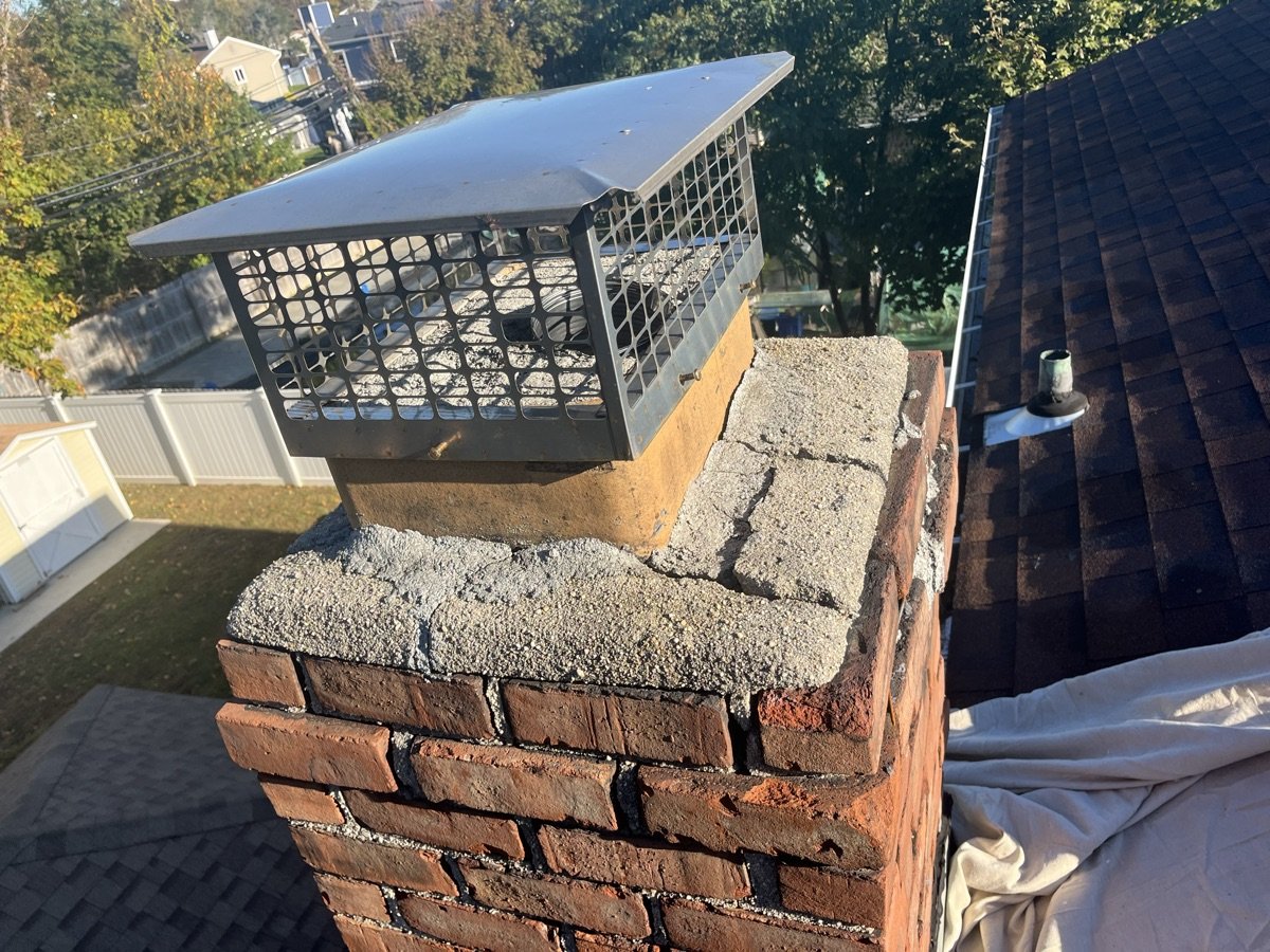 Chimney with new cap installed on cracked crown needing further repair