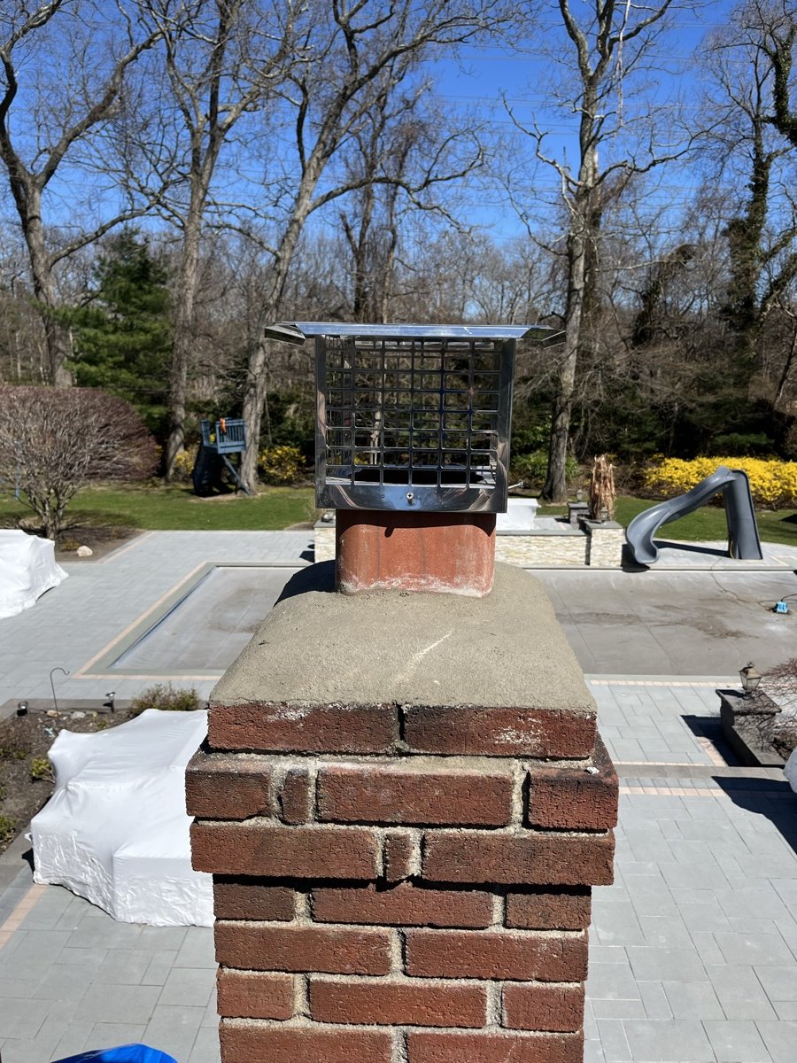 Finished chimney work with new cap by Capstone